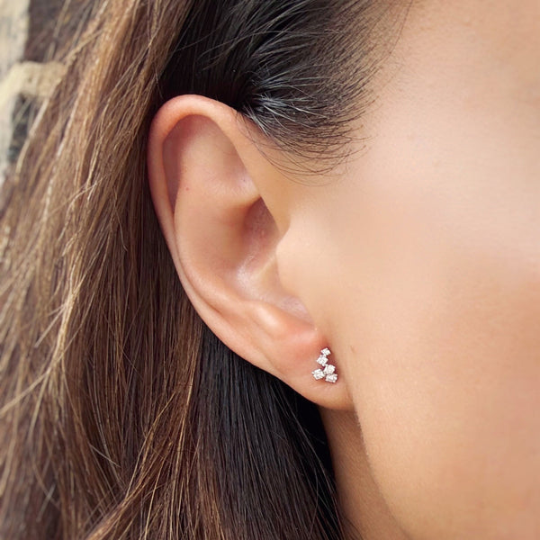 Close-up of an ear wearing a scatter diamond stud earring